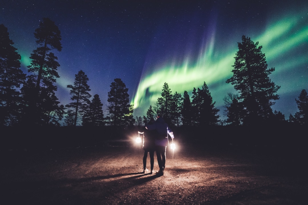 Mattia and Heini Bonagura watching Northern Lights in ivalo Lapland Finland. Photo by Alexander Kuznetsov / Aurora Hunting