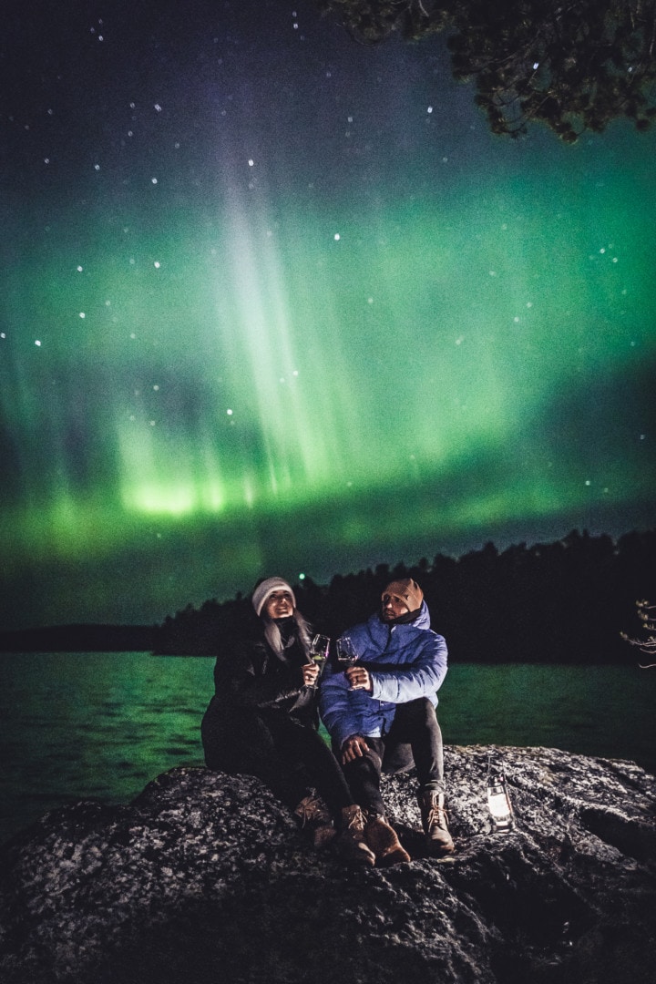 Romantic moment under the Northern Lights in ivalo Lapland Finland. Photo by Alexander Kuznetsov / Aurora Hunting