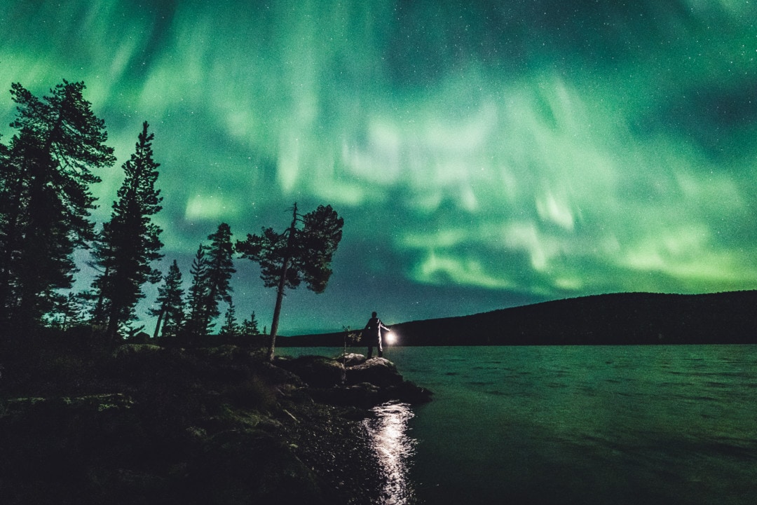 Watching the northern Lights on a lake in Ivalo Inari Lapland Finland. 27.09.2019. Photo by Alexander Kuznetsov / Aurora Hunting.